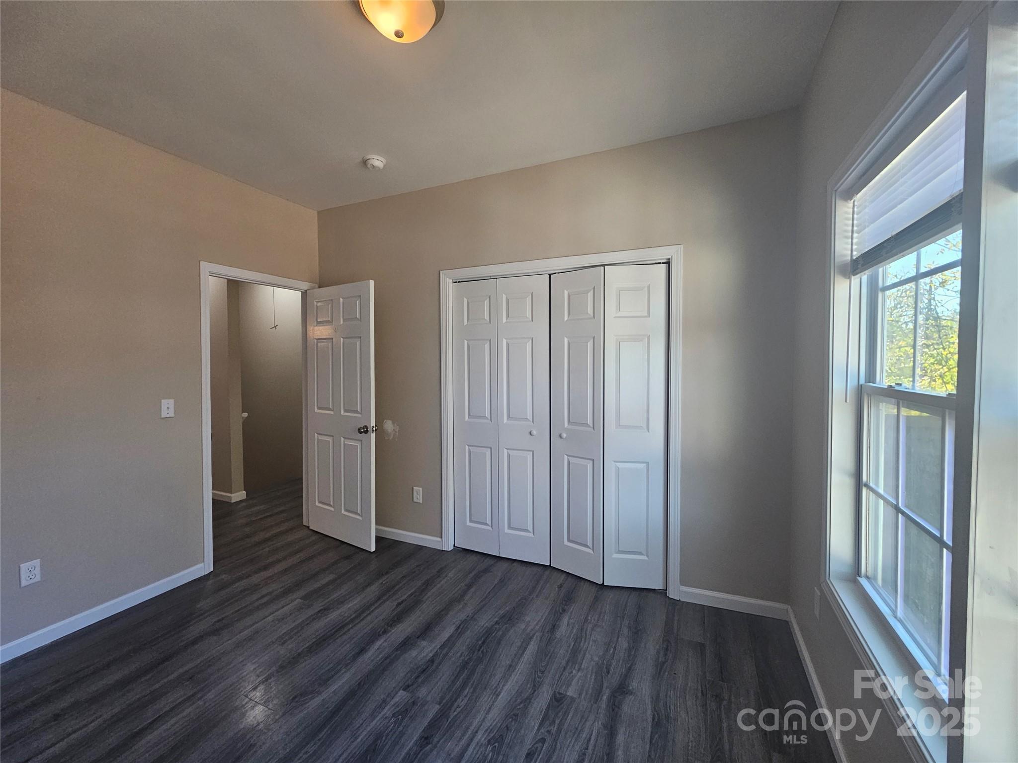 106 Steinkuhler Street, Unit 6 Chester, SC 29706 - Photo 22 of 25 an empty room with wooden floor and windows
