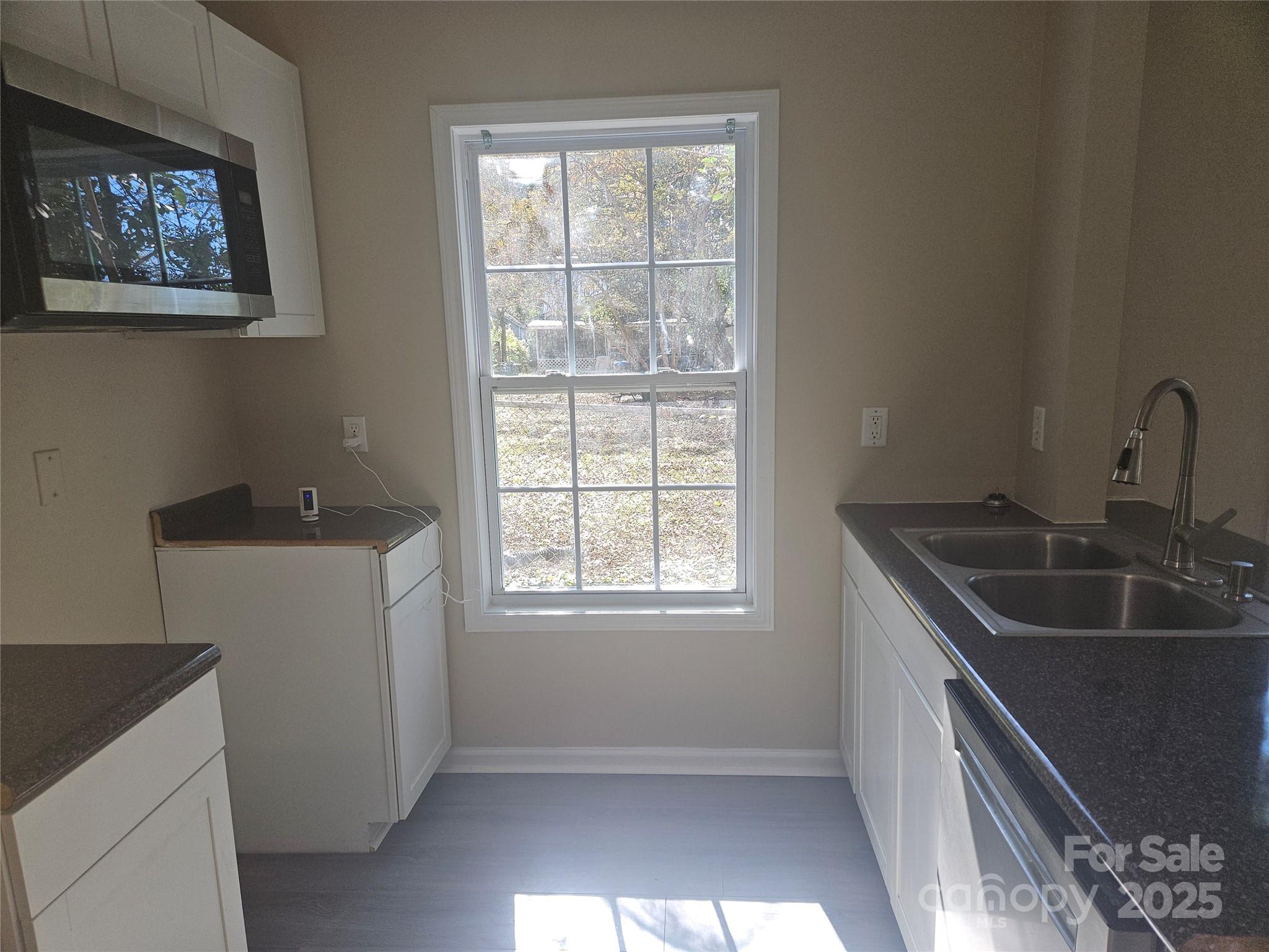 106 Steinkuhler Street, Unit 6 Chester, SC 29706 - Photo 3 of 25 a kitchen with a sink and a window