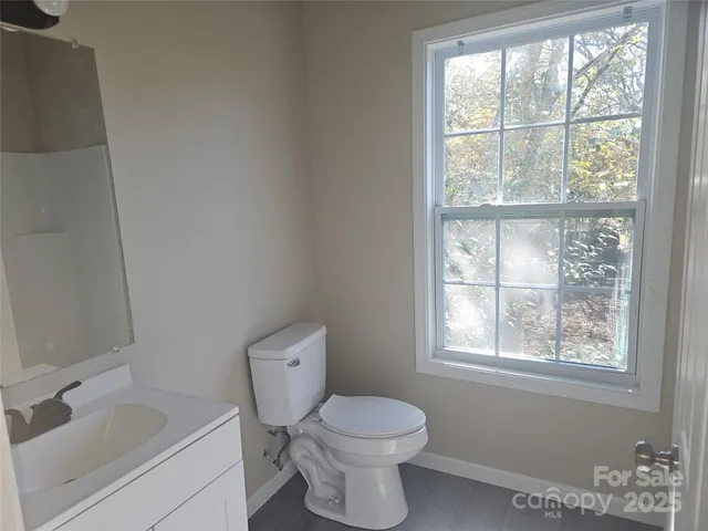 a white toilet sitting next to a bathroom sink