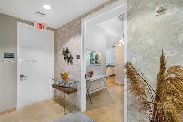a bathroom with a granite countertop sink a toilet and a mirror