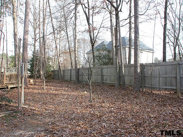 1213 Oakside Court Raleigh, NC 27609 - Photo 12 of 13 a backyard of a house with lots of green space