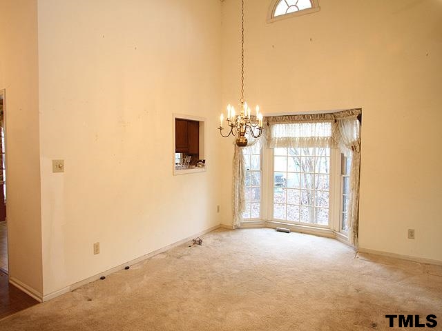 1213 Oakside Court Raleigh, NC 27609 - Photo 4 of 13 a view of an empty room with a window