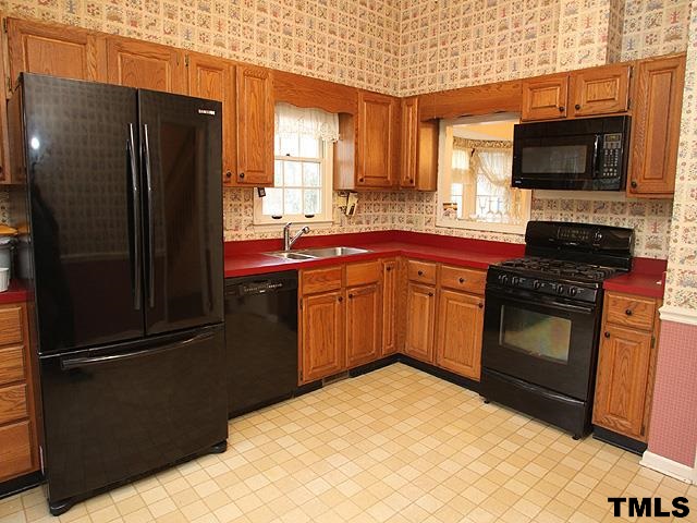 1213 Oakside Court Raleigh, NC 27609 - Photo 5 of 13 a kitchen with stainless steel appliances granite countertop a refrigerator stove and microwave
