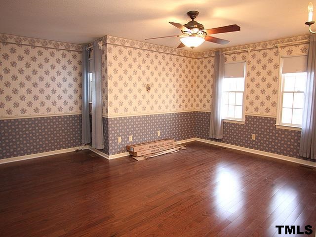 1213 Oakside Court Raleigh, NC 27609 - Photo 7 of 13 a view of an empty room with wooden floor and a window