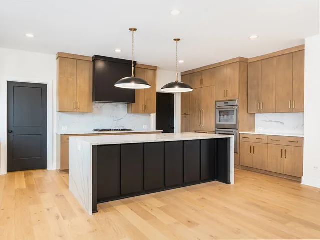 a kitchen with a sink a counter space appliances and cabinets