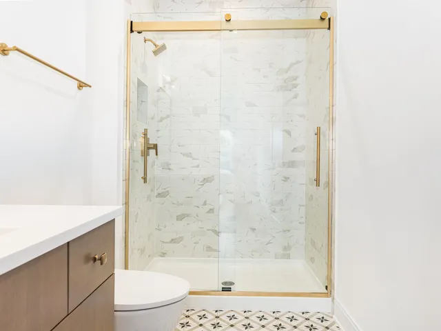 a bathroom with a shower and a toilet