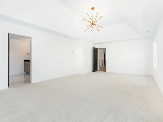 an empty room with windows and painted walls