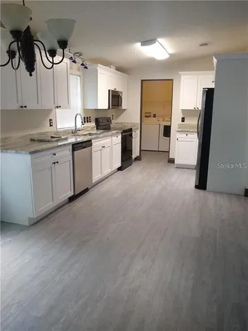 a kitchen with refrigerator and window