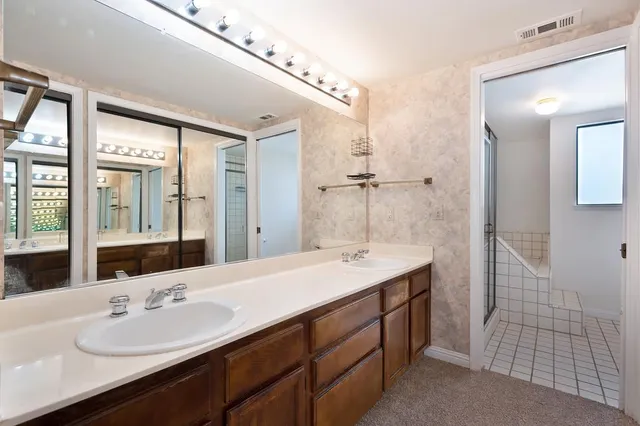 a bathroom with a sink double vanity and a mirror