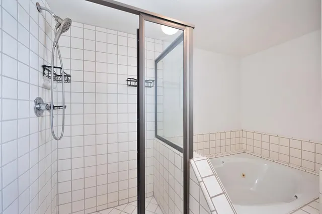 a bathroom with a bathtub and shower