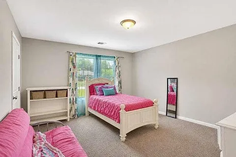a spacious bedroom with a bed and a couch