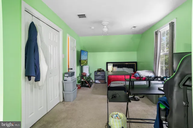 a bedroom with furniture and a flat screen tv