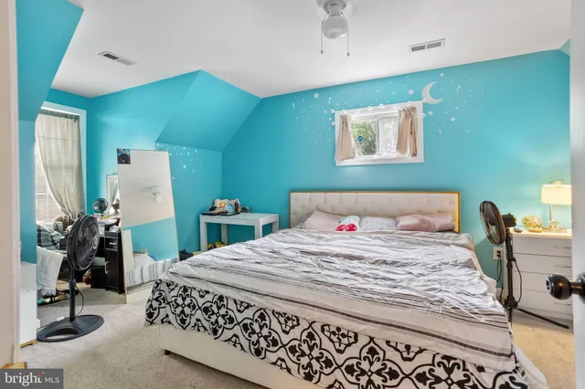 a bedroom with a bed and a mirror