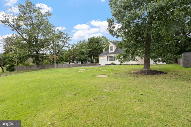 a view of a yard with a house and large trees