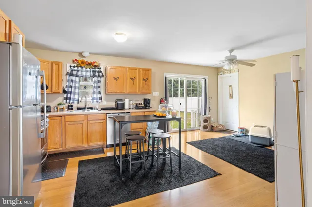 a kitchen with a table chairs refrigerator and cabinets