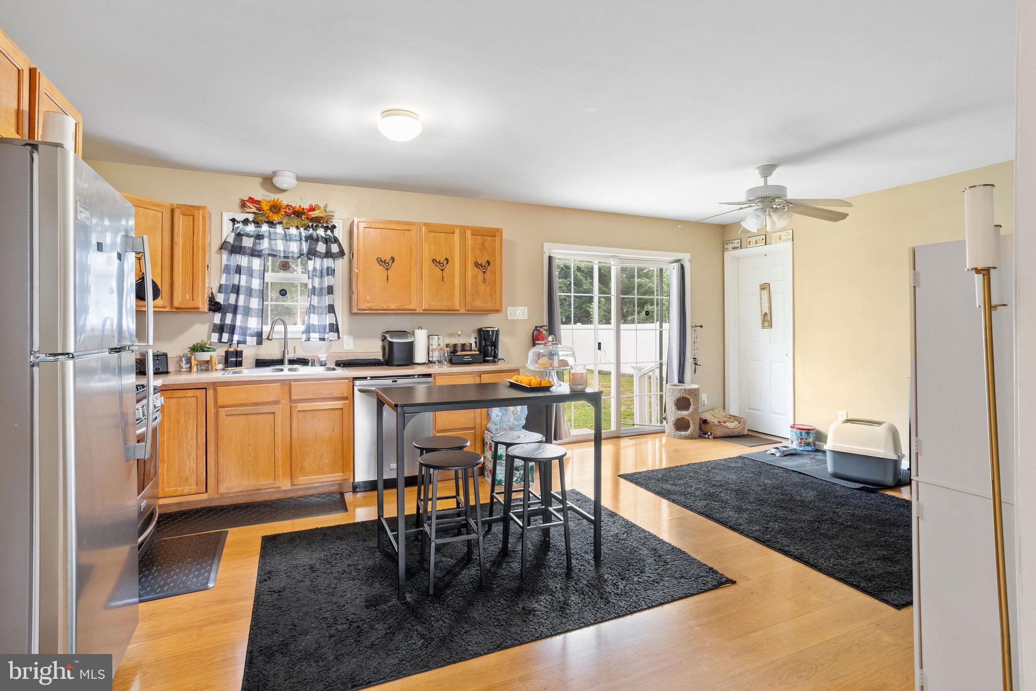 954 East Walnut Road Vineland, NJ 08360 - Photo 7 of 25 a kitchen with a table chairs refrigerator and cabinets