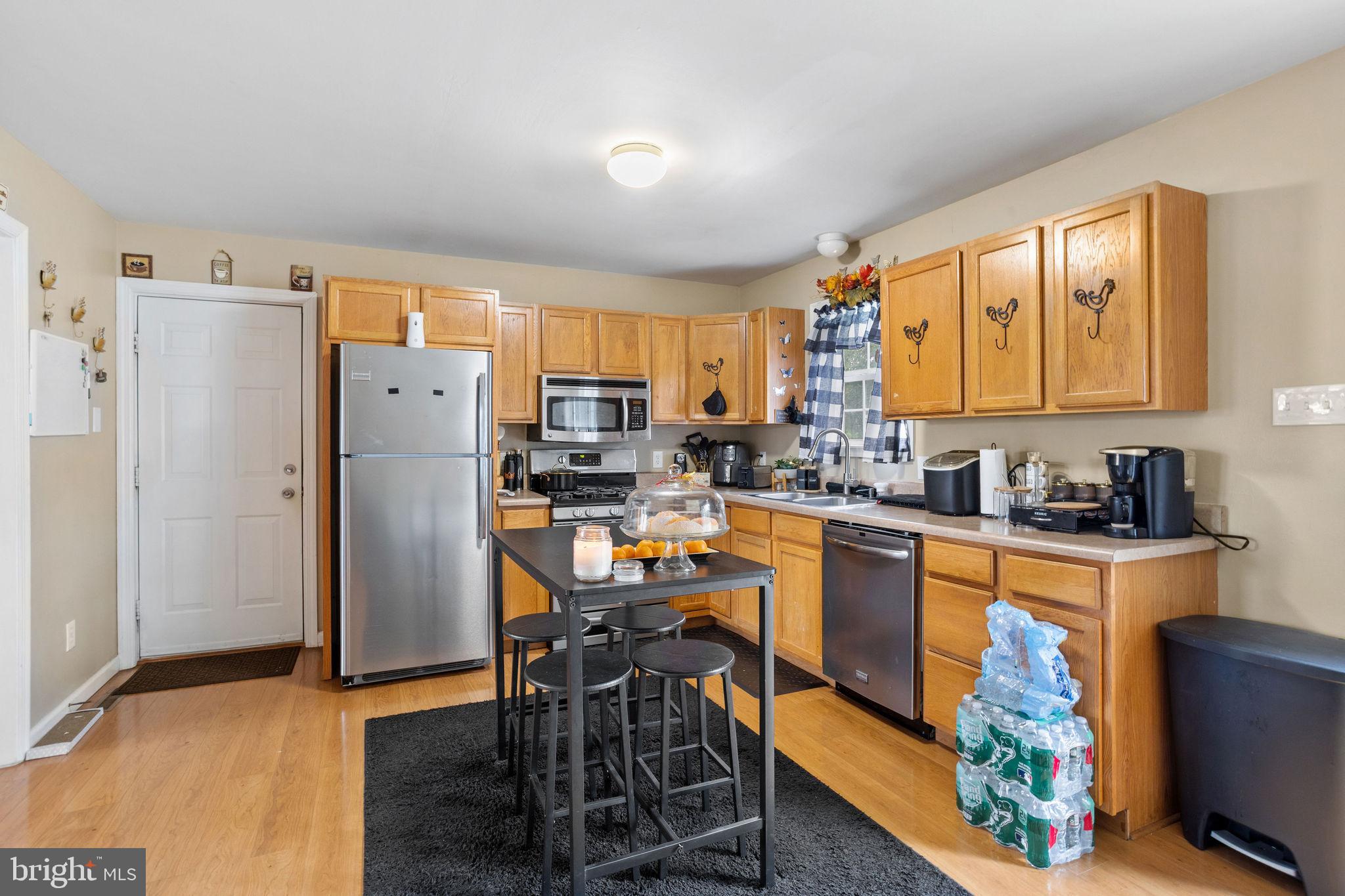 954 East Walnut Road Vineland, NJ 08360 - Photo 10 of 25 a kitchen with stainless steel appliances a refrigerator a sink a stove a table and chairs