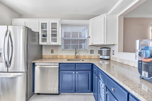a kitchen with stainless steel appliances granite countertop a refrigerator and a sink