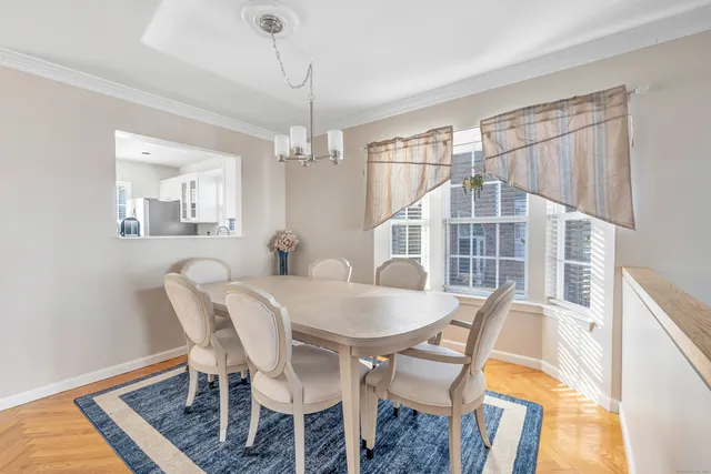 a view of a dining room with furniture and chandelier