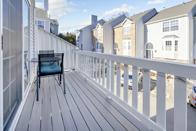 a view of a balcony with wooden floor