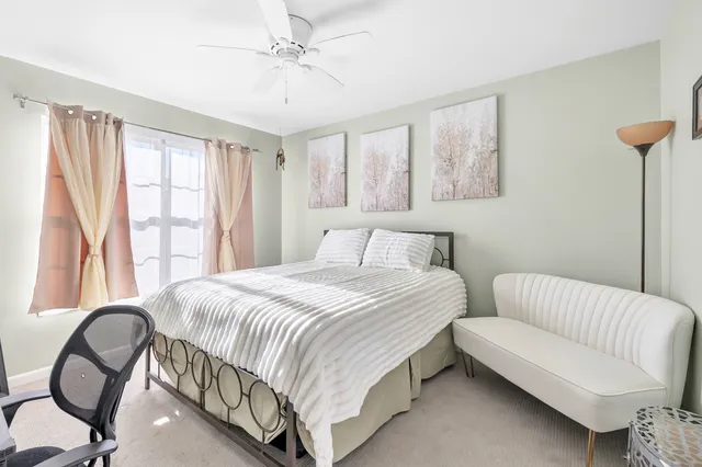 a bedroom with a bed and a large window