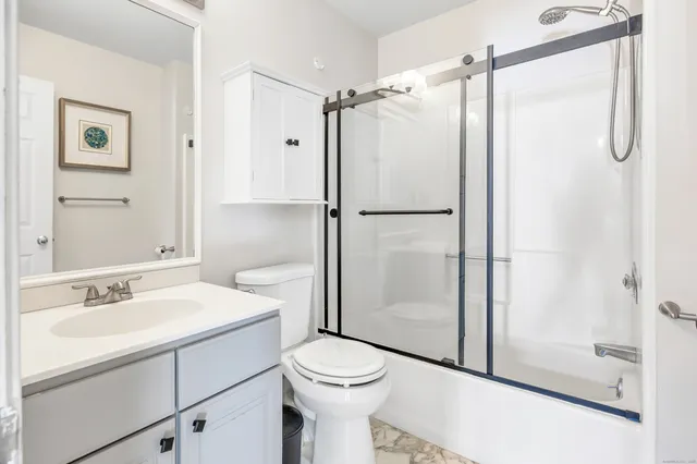 a bathroom with a sink toilet and shower