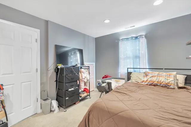 a bedroom with a bed and a mirror