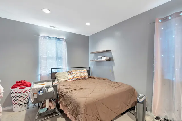 a bedroom with a bed and cabinets