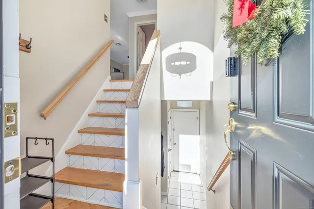 a view of entryway with furniture and wooden floor