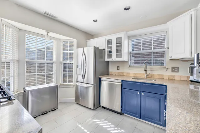 a kitchen with refrigerator and window