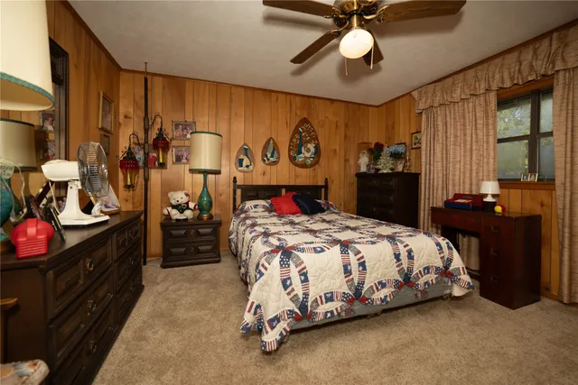 a spacious bedroom with a bed and a chandelier