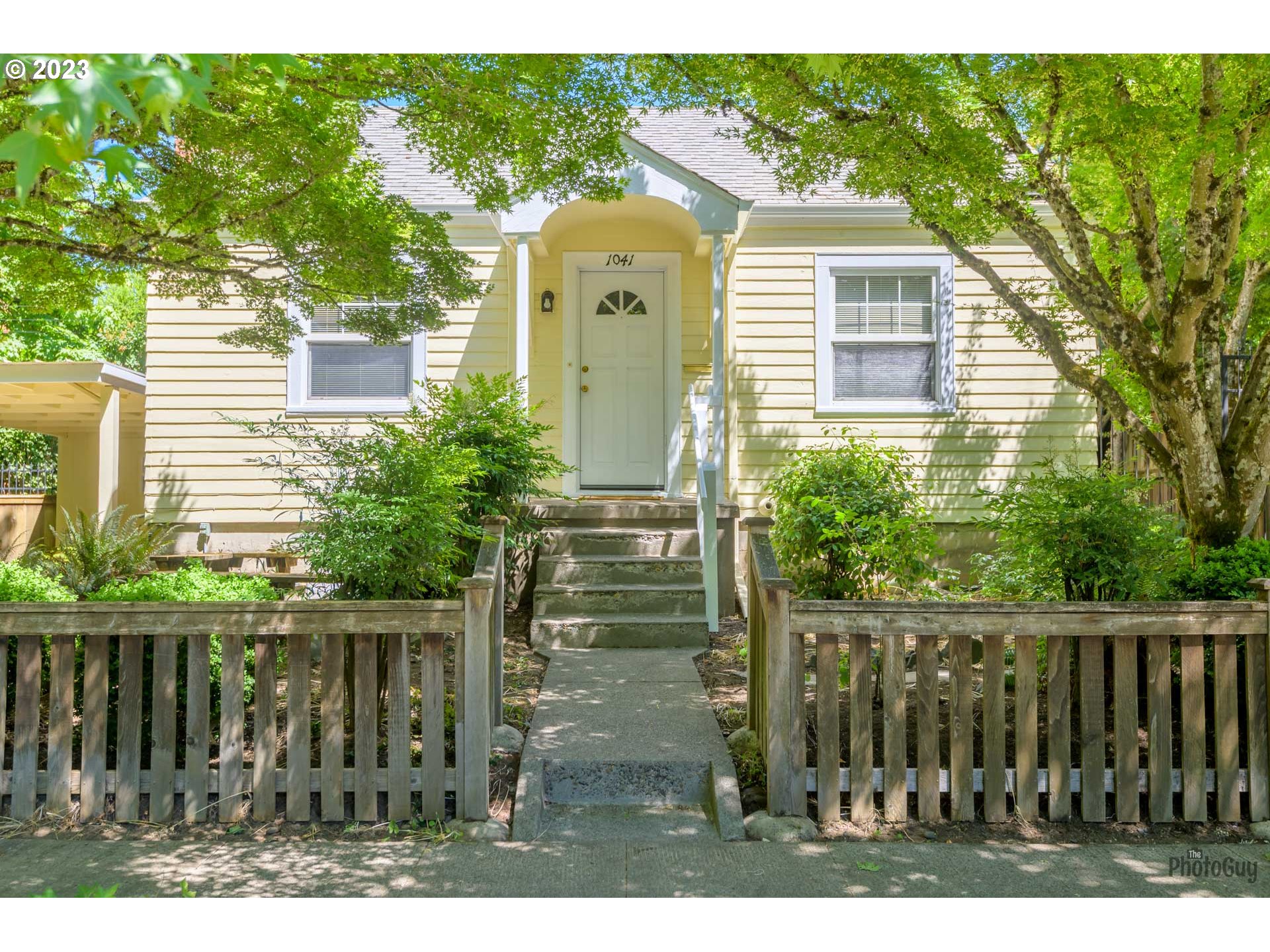 a front view of a house with a garden