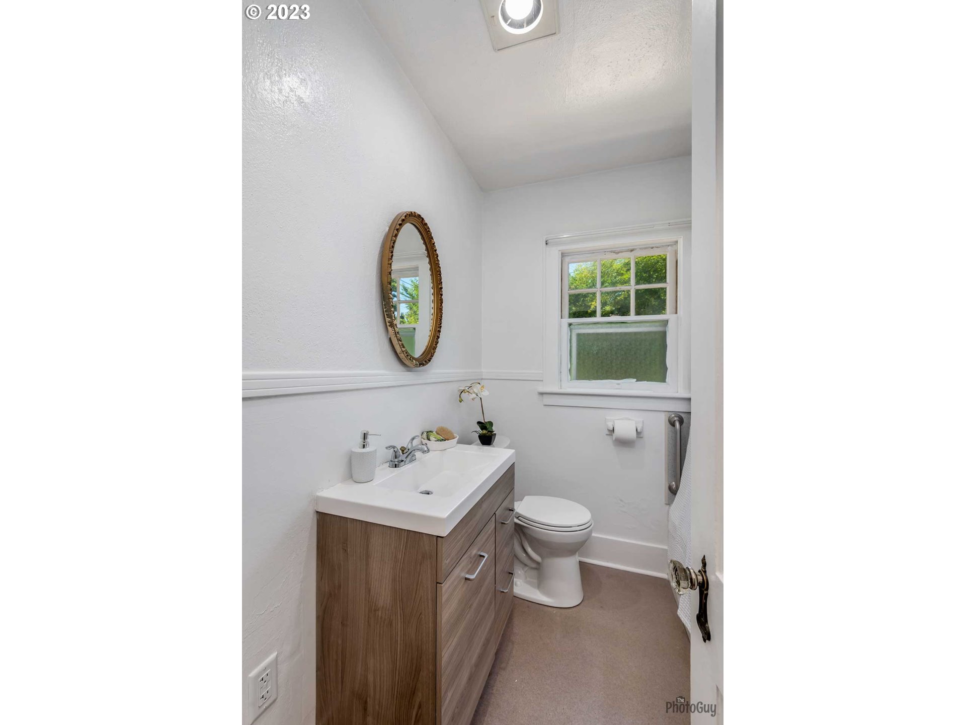 1041 Madison Street Eugene, OR 97402 - Photo 13 of 34 a bathroom with a toilet sink and mirror