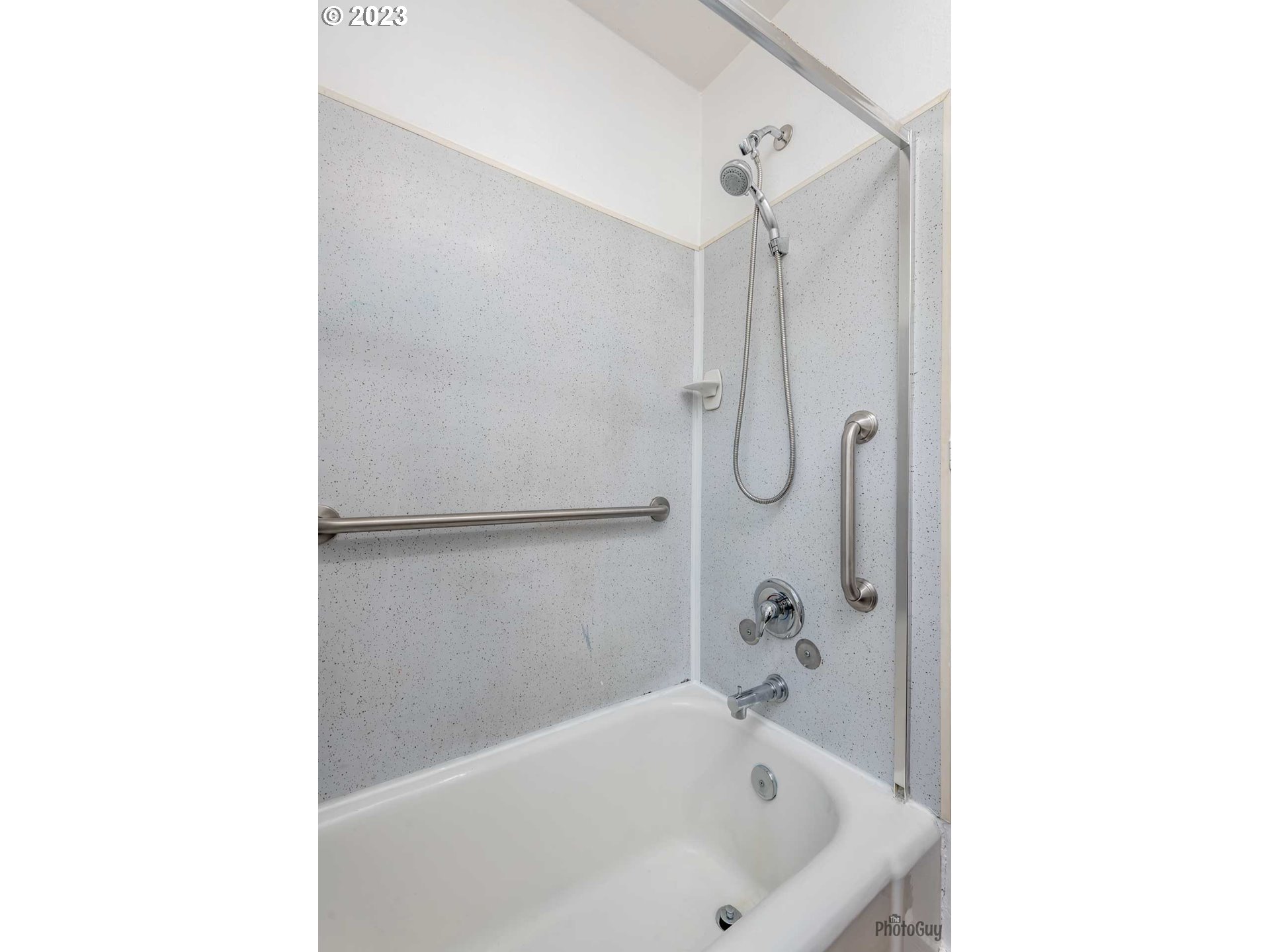 1041 Madison Street Eugene, OR 97402 - Photo 14 of 34 a white bath tub sitting next to a shower