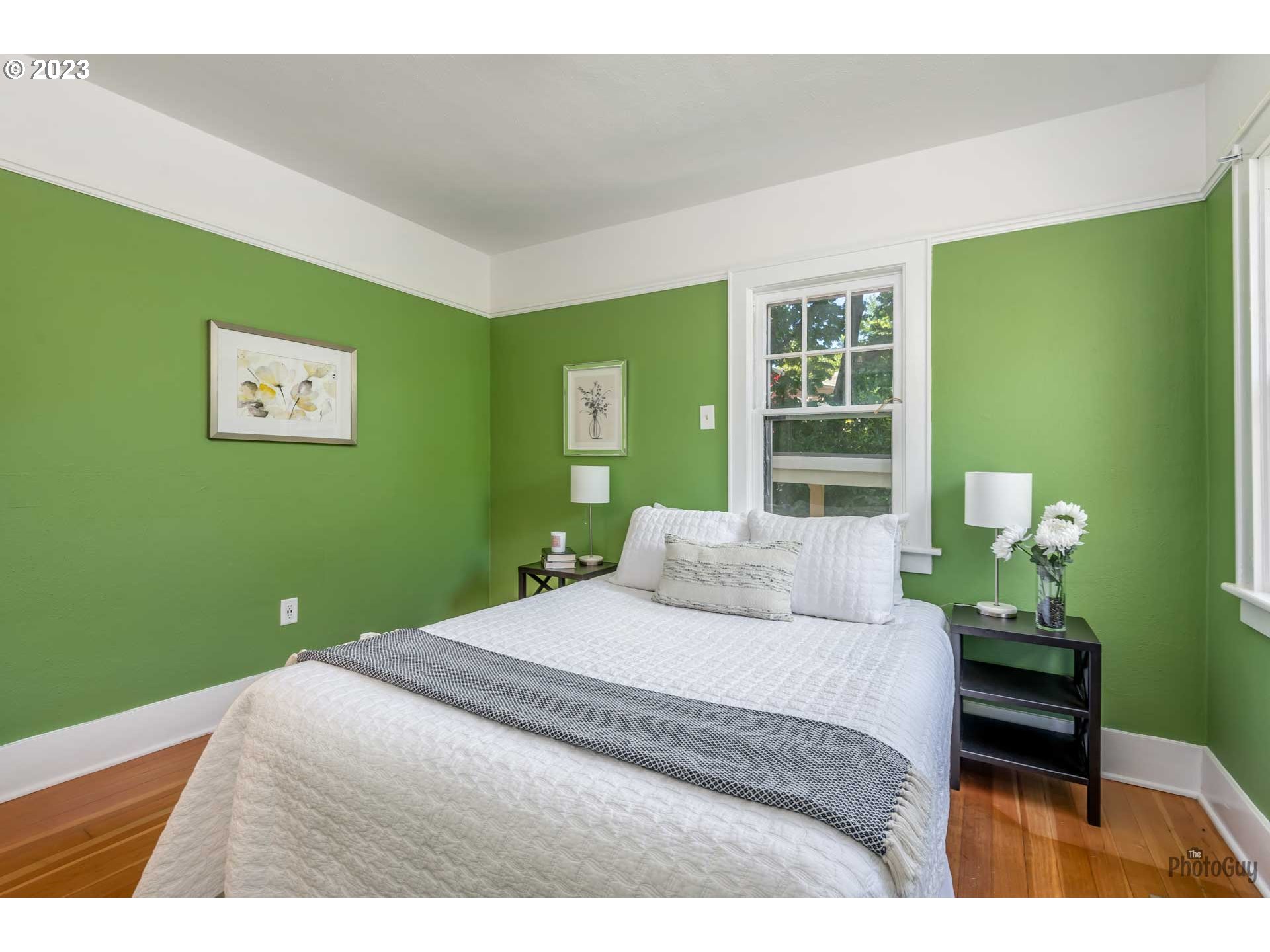 1041 Madison Street Eugene, OR 97402 - Photo 16 of 34 a bedroom with a bed and a potted plant