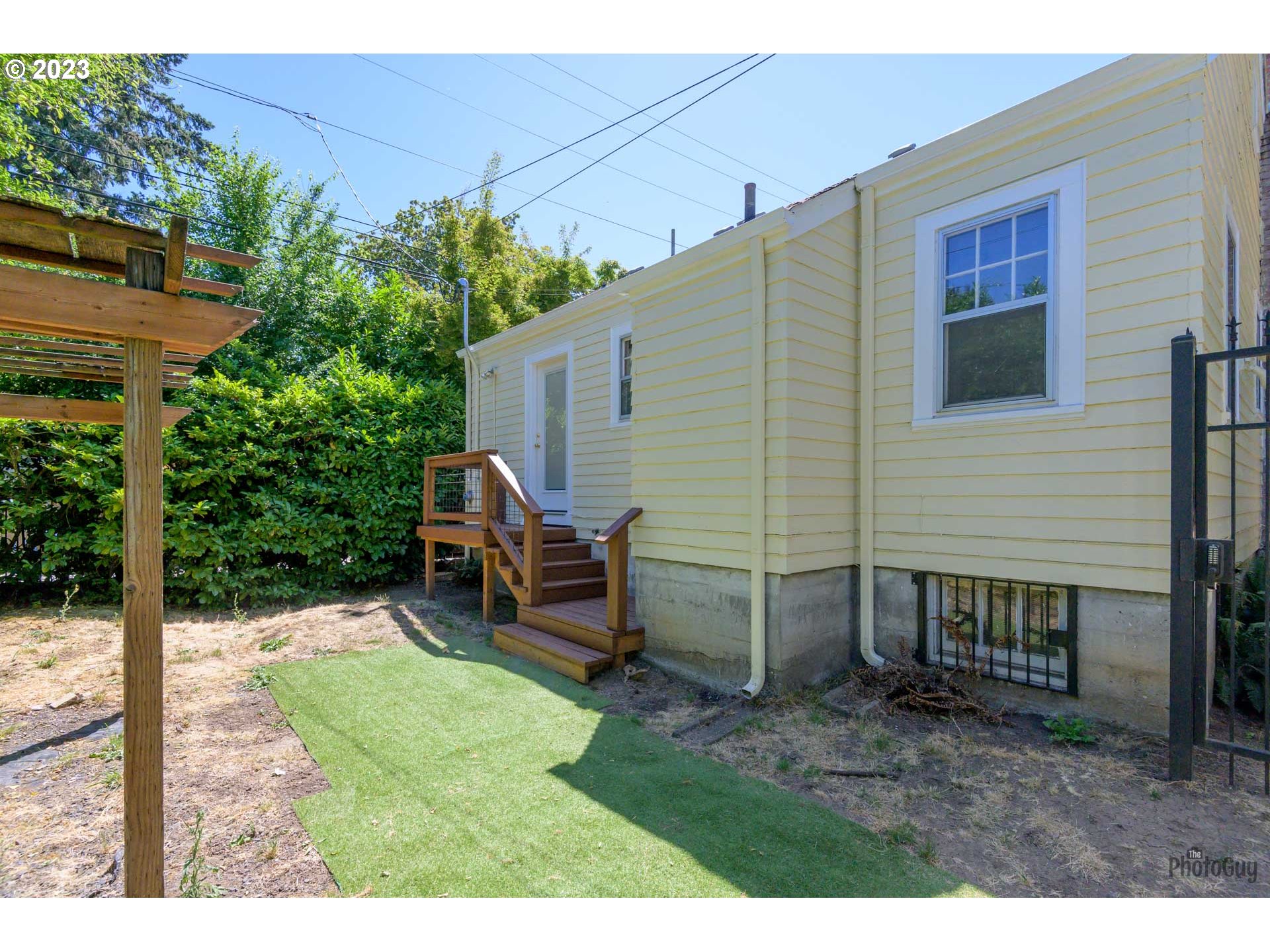 1041 Madison Street Eugene, OR 97402 - Photo 28 of 34 a view of a backyard with chairs and a potted plant