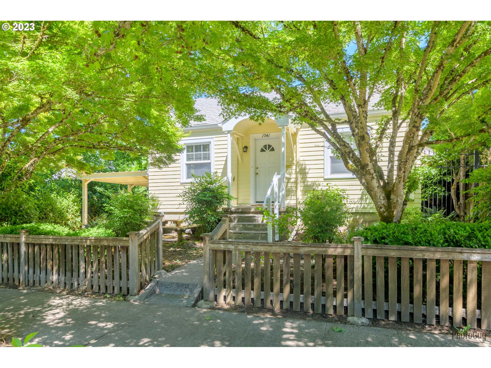 1041 Madison Street Eugene, OR 97402 - Photo 32 of 34 a view of house with backyard and a garden