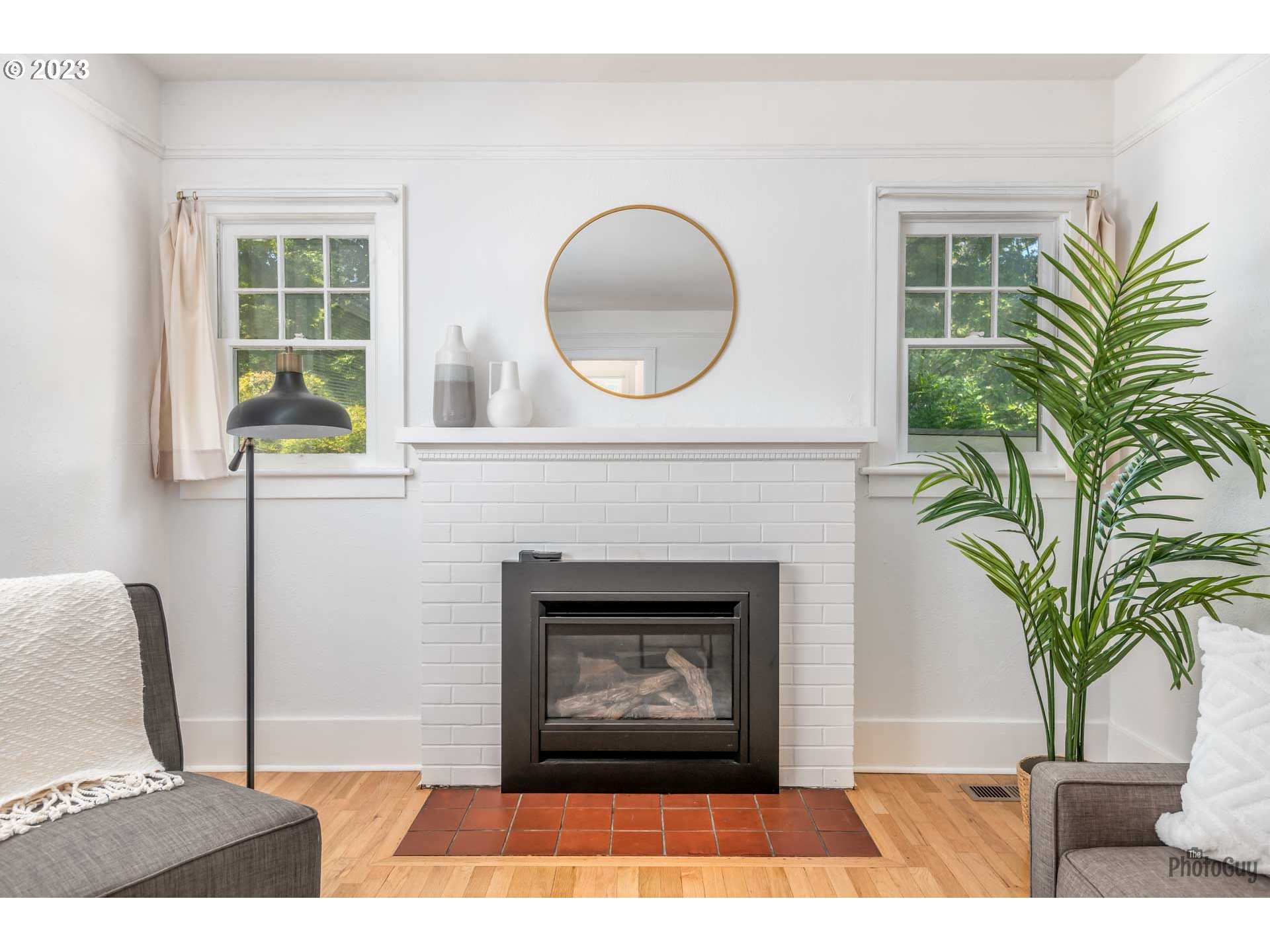 1041 Madison Street Eugene, OR 97402 - Photo 7 of 34 a living room with a fireplace and a potted plant