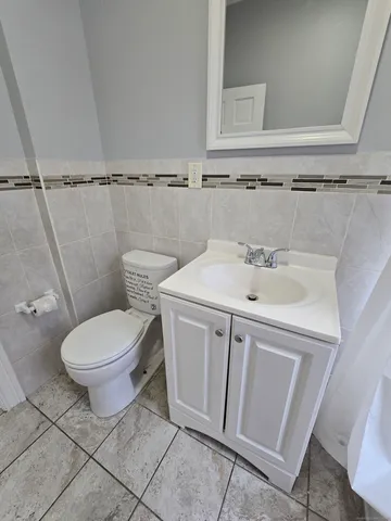 a white toilet sitting next to a bathroom sink