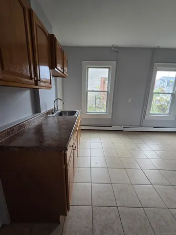 a kitchen with a sink a stove and cabinets