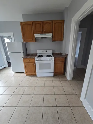a kitchen with a stove top oven and cabinets