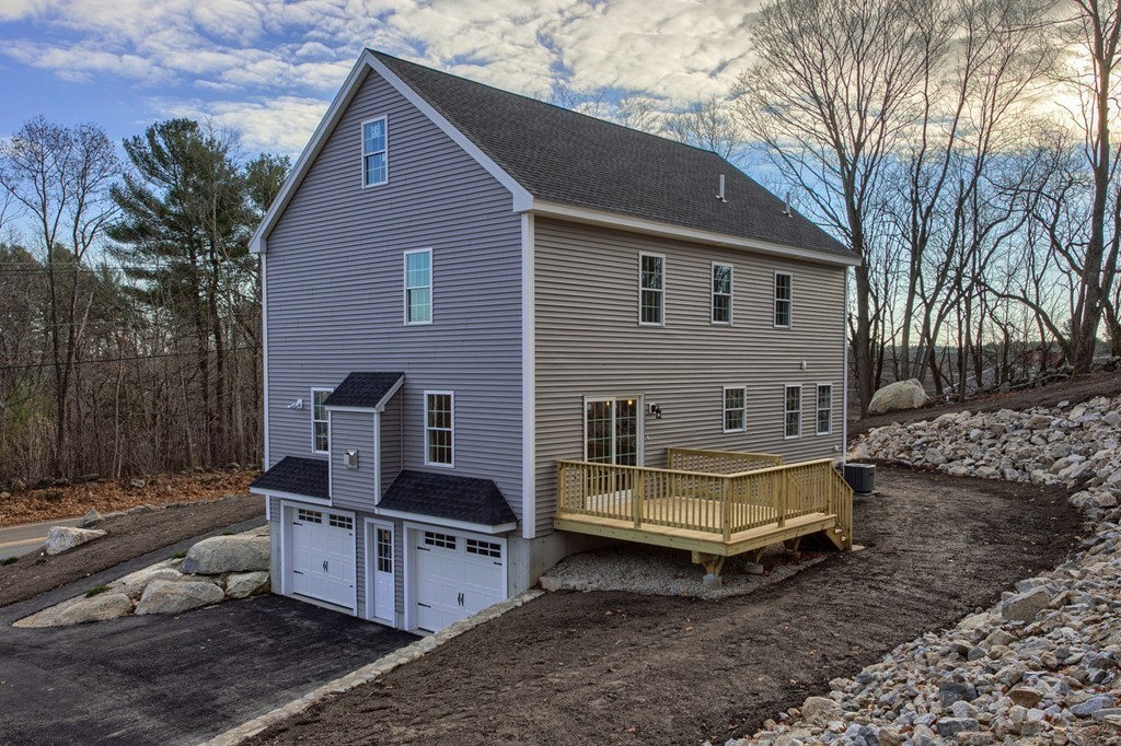 1646 Mammoth Road Dracut, MA 01826 - Photo 3 of 27 a front view of a house with garden