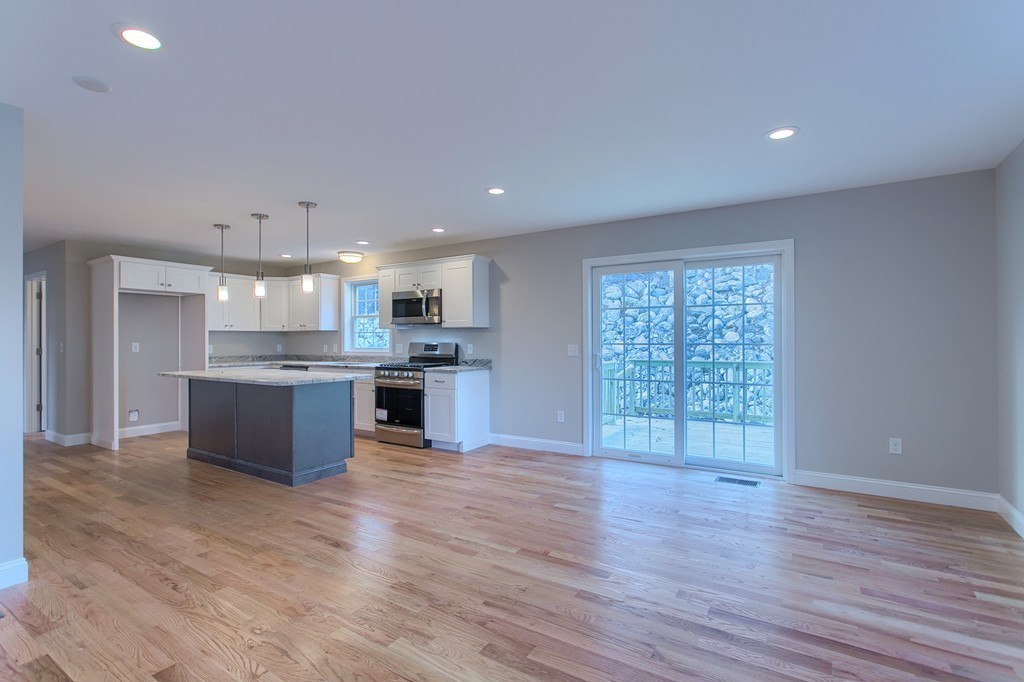1646 Mammoth Road Dracut, MA 01826 - Photo 9 of 27 a large kitchen with stainless steel appliances granite countertop a large counter top a wooden floors and a large window