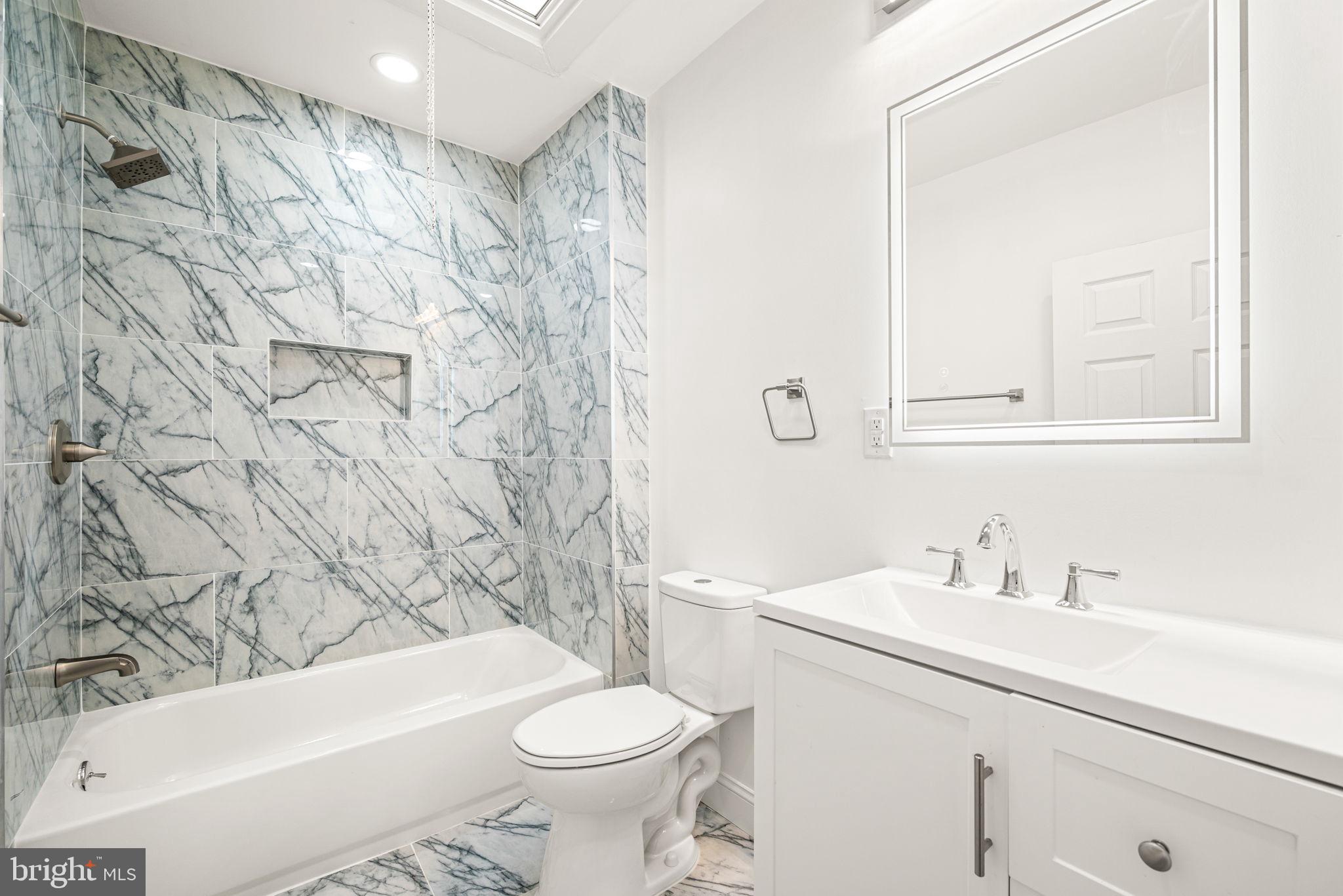 6128 Chestnut Street Philadelphia, PA 19139 - Photo 6 of 10 a bathroom with a sink a toilet and a bathtub