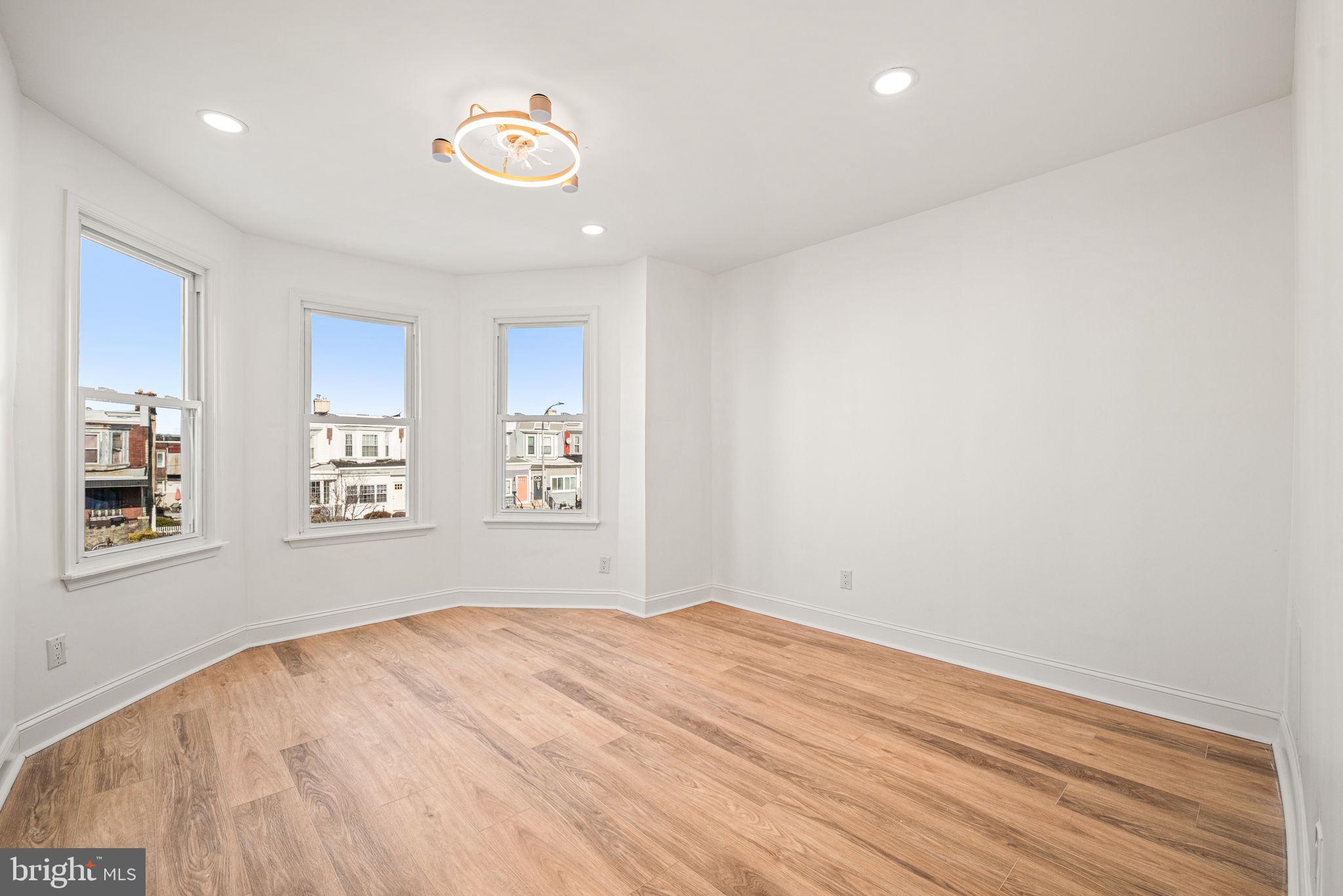 6128 Chestnut Street Philadelphia, PA 19139 - Photo 7 of 10 a view of empty room with wooden floor and fan