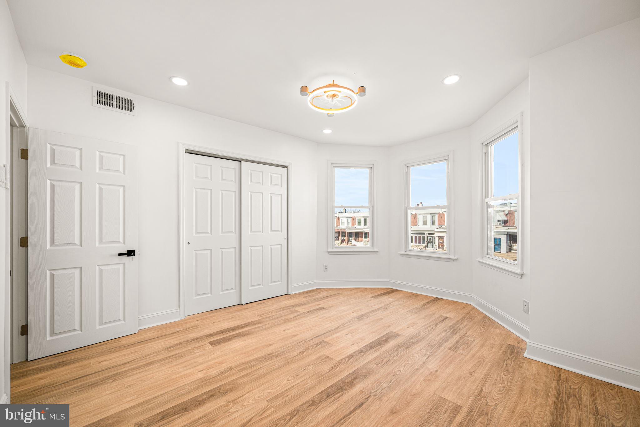 6128 Chestnut Street Philadelphia, PA 19139 - Photo 8 of 10 a view of empty room with wooden floor and fan