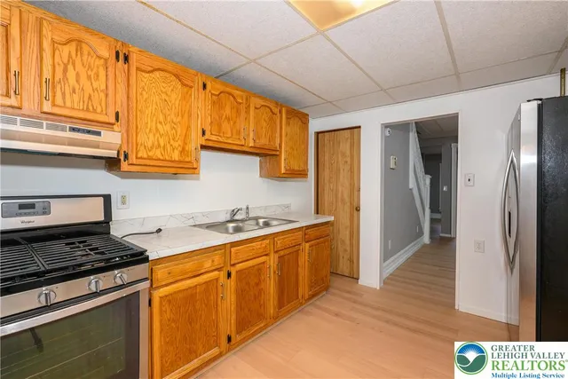 a kitchen with stainless steel appliances granite countertop a stove and a refrigerator