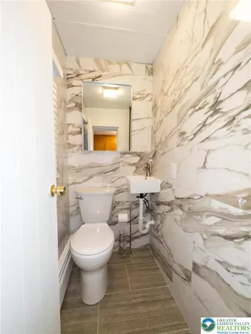 a bathroom with a toilet and a mirror