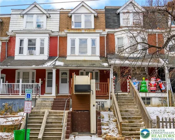 a view of a brick house with large windows