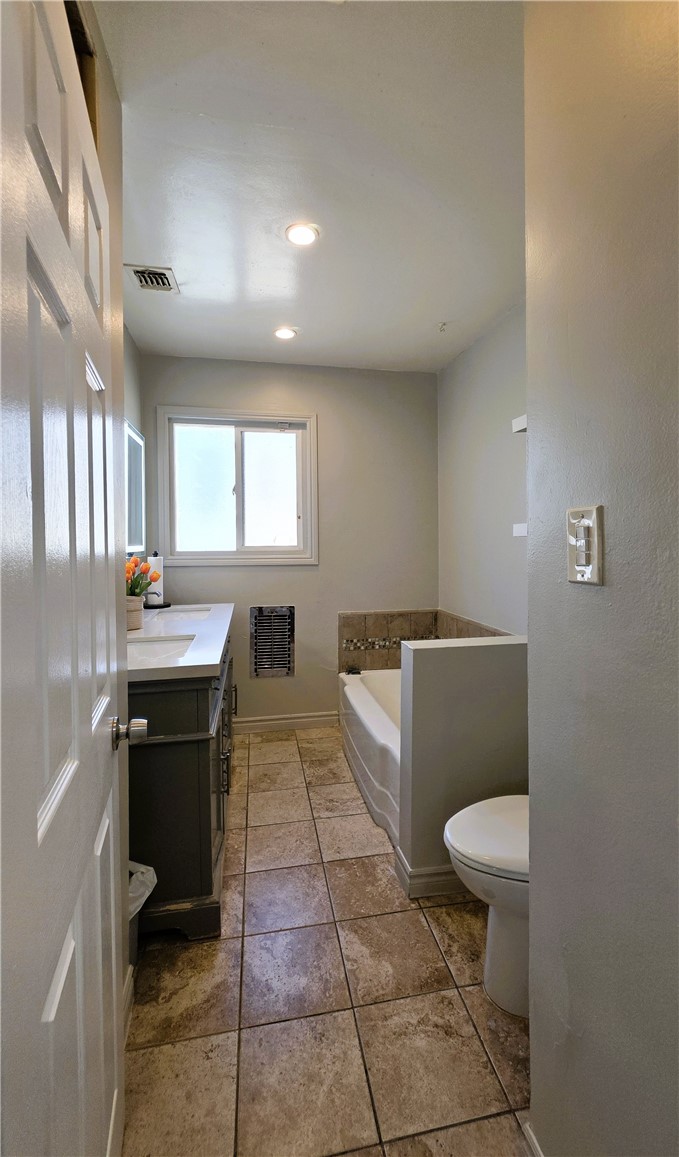 6637 Capps Avenue Reseda, CA 91335 - Photo 15 of 23 a bathroom with a sink a toilet and a mirror
